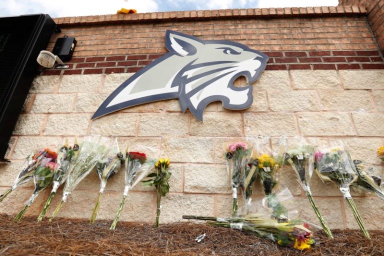 Football team that lost coach in deadly school shooting to play again